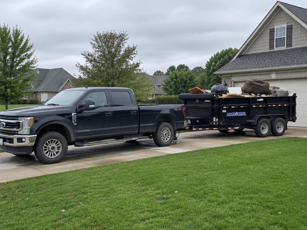 Jace's truck loaded with furniture and boxes on a residential driveway